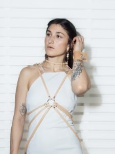 a woman wearing a white dress with we got cookies fashion harness
